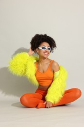 Photo of Fashionable portrait of beautiful Brazilian woman in stylish outfit on white background