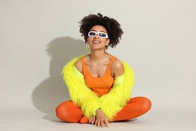 Photo of Fashionable portrait of beautiful Brazilian woman in stylish outfit on white background