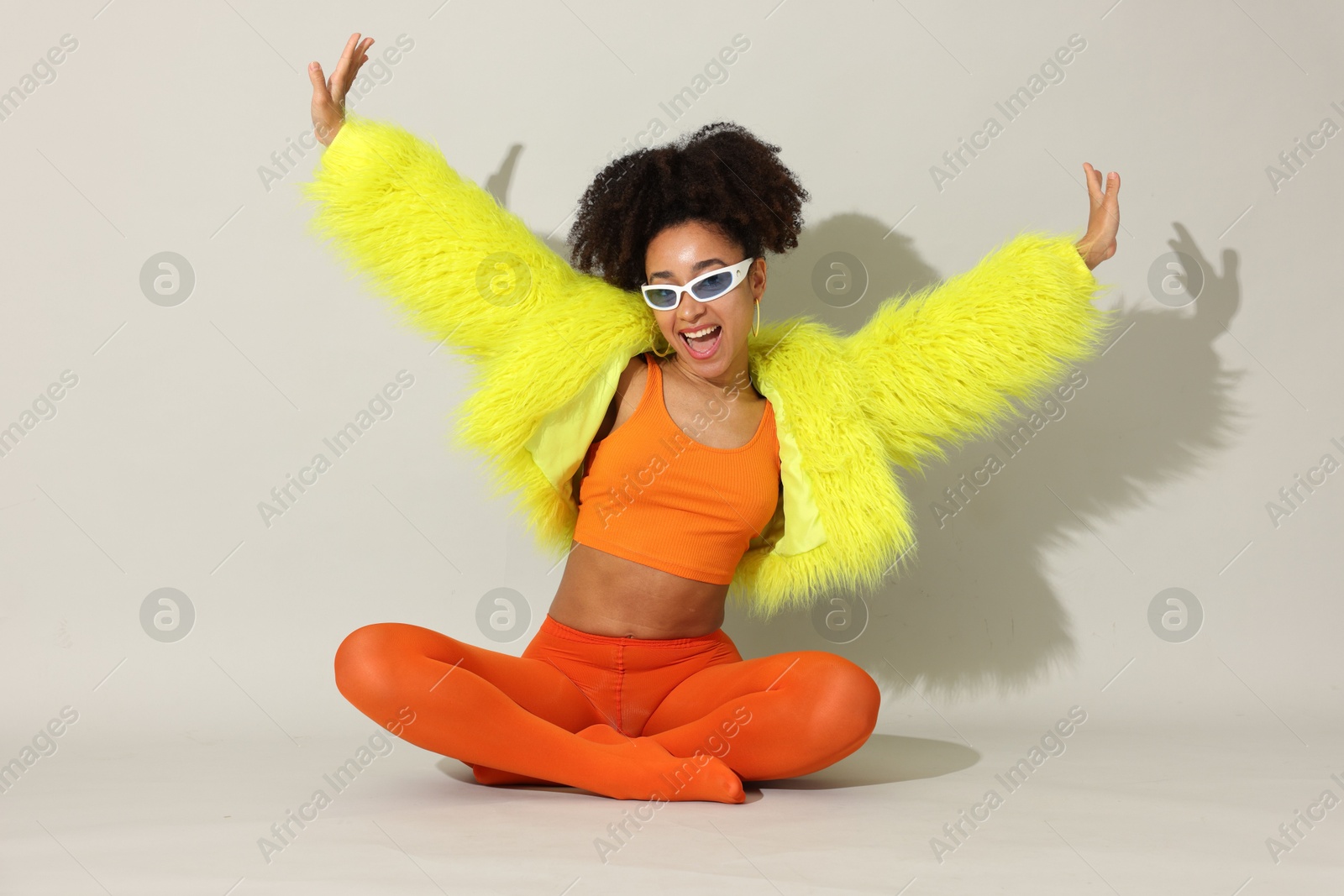 Photo of Fashionable portrait of beautiful Brazilian woman in stylish outfit on white background