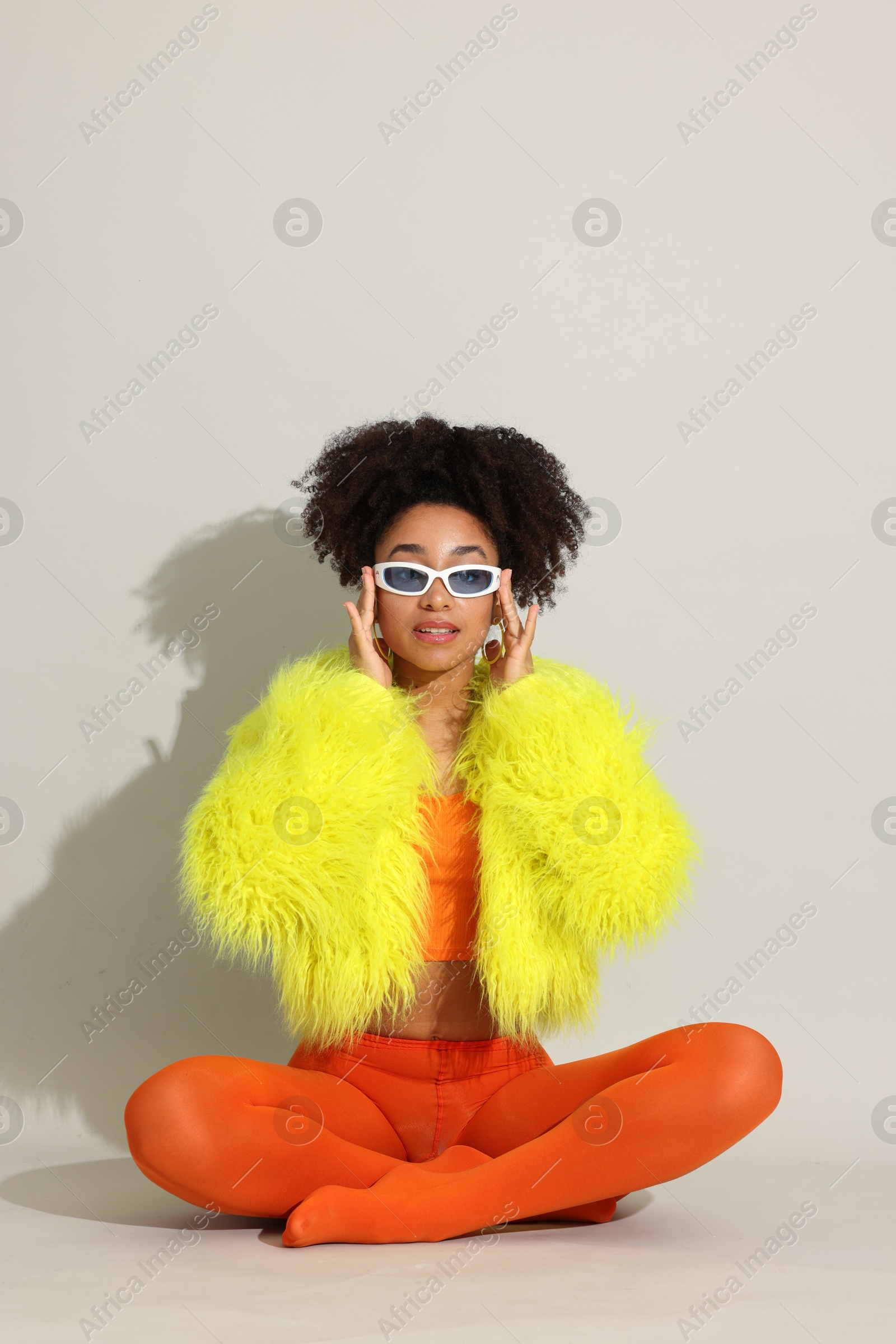 Photo of Fashionable portrait of beautiful Brazilian woman in stylish outfit on white background