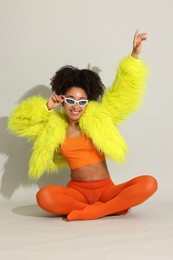 Photo of Fashionable portrait of beautiful Brazilian woman in stylish outfit on white background