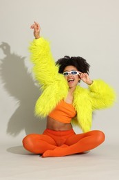 Photo of Fashionable portrait of beautiful Brazilian woman in stylish outfit on white background