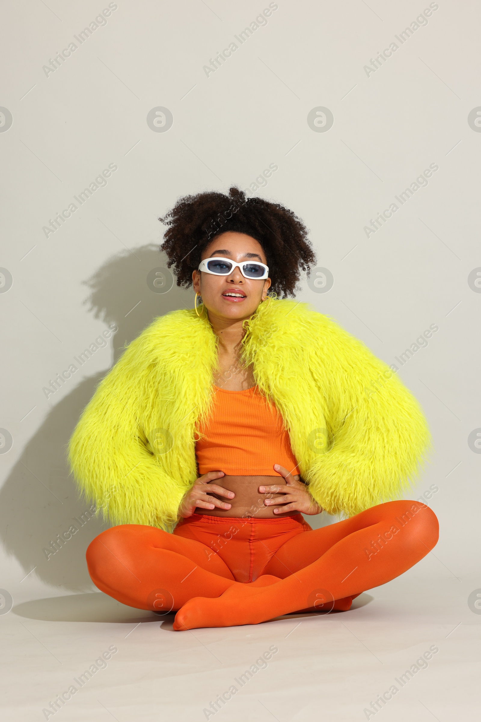 Photo of Fashionable portrait of beautiful Brazilian woman in stylish outfit on white background