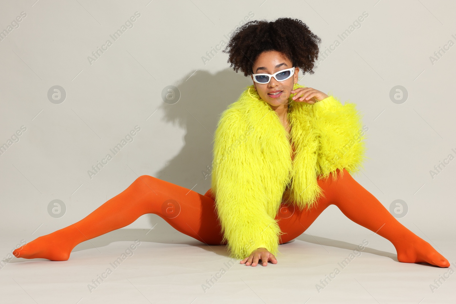 Photo of Fashionable portrait of beautiful Brazilian woman in stylish outfit on white background