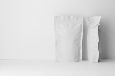 Photo of Zipper stand-up pouches on white background. Mockup for design