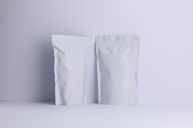 Photo of Zipper stand-up pouches on white background. Mockup for design