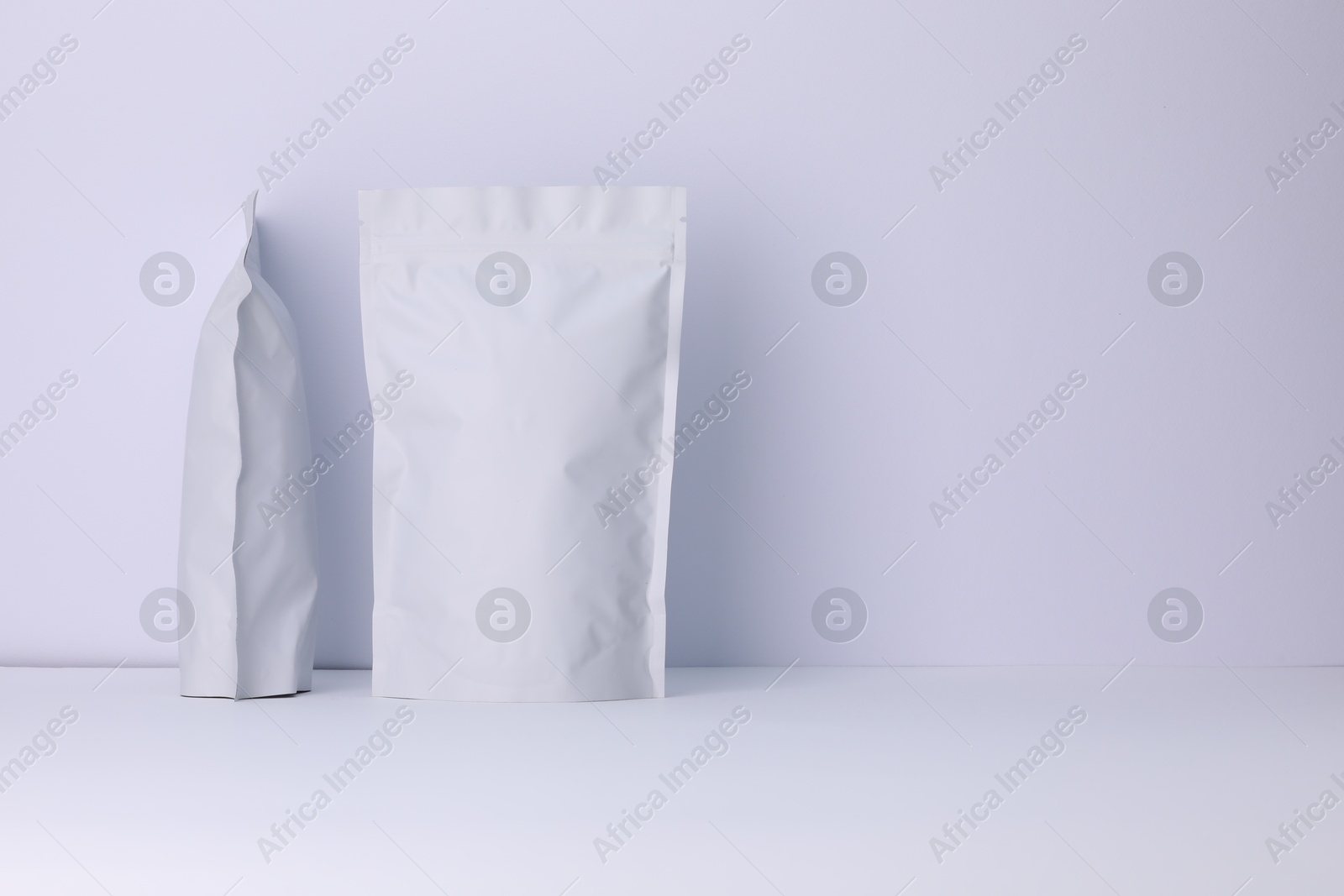 Zipper stand-up pouches on white background. Mockup for design Photo of Zipper stand-up pouches on white background. Mockup for design