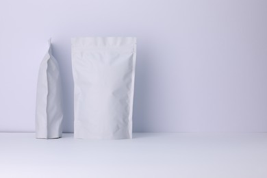 Photo of Zipper stand-up pouches on white background. Mockup for design