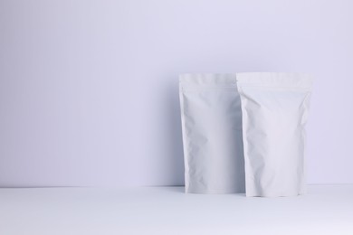 Photo of Zipper stand-up pouches on white background. Mockup for design