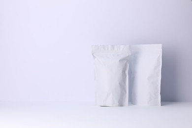 Photo of Zipper stand-up pouches on white background. Mockup for design