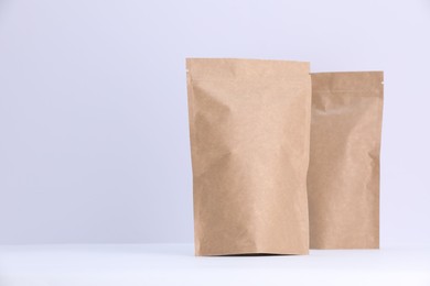 Photo of Zipper stand-up pouches on white background. Mockup for design