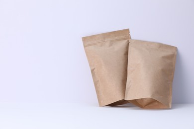 Photo of Zipper stand-up pouches on white background. Mockup for design