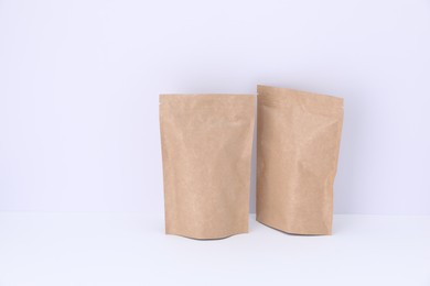 Photo of Zipper stand-up pouches on white background. Mockup for design
