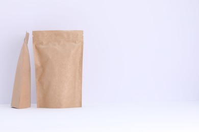 Photo of Zipper stand-up pouches on white background. Mockup for design