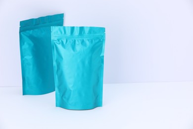 Photo of Zipper stand-up pouches on white background. Mockup for design