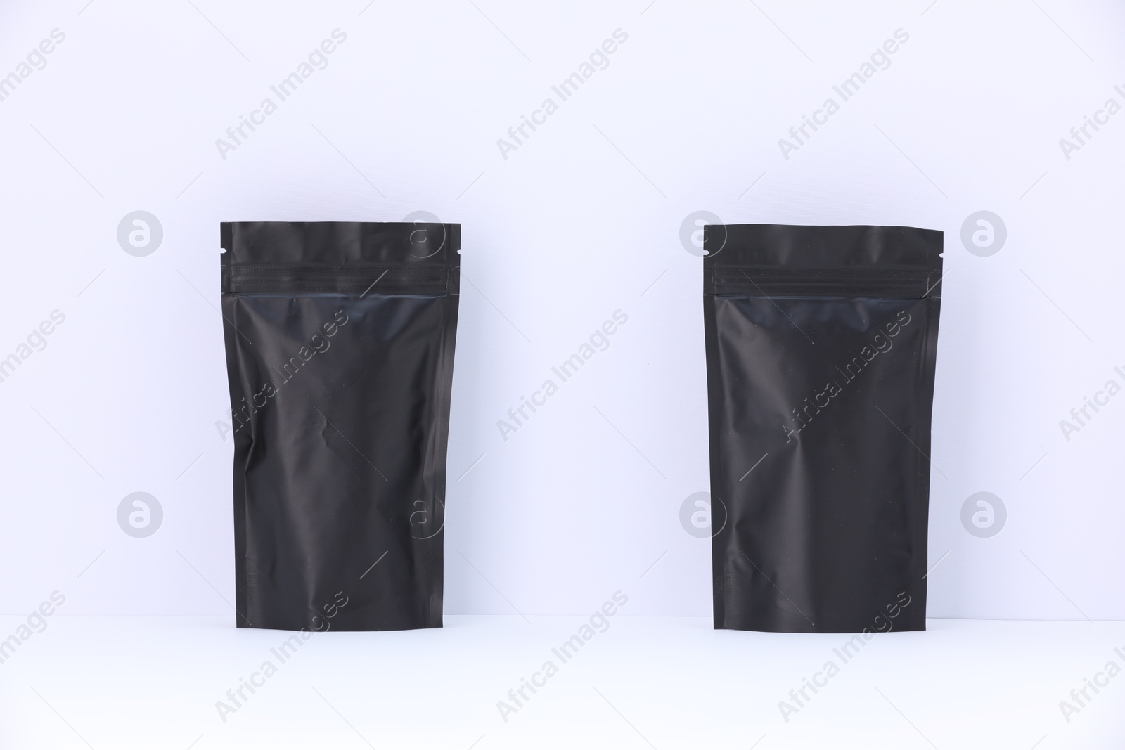 Zipper stand-up pouches on white background. Mockup for design Photo of Zipper stand-up pouches on white background. Mockup for design