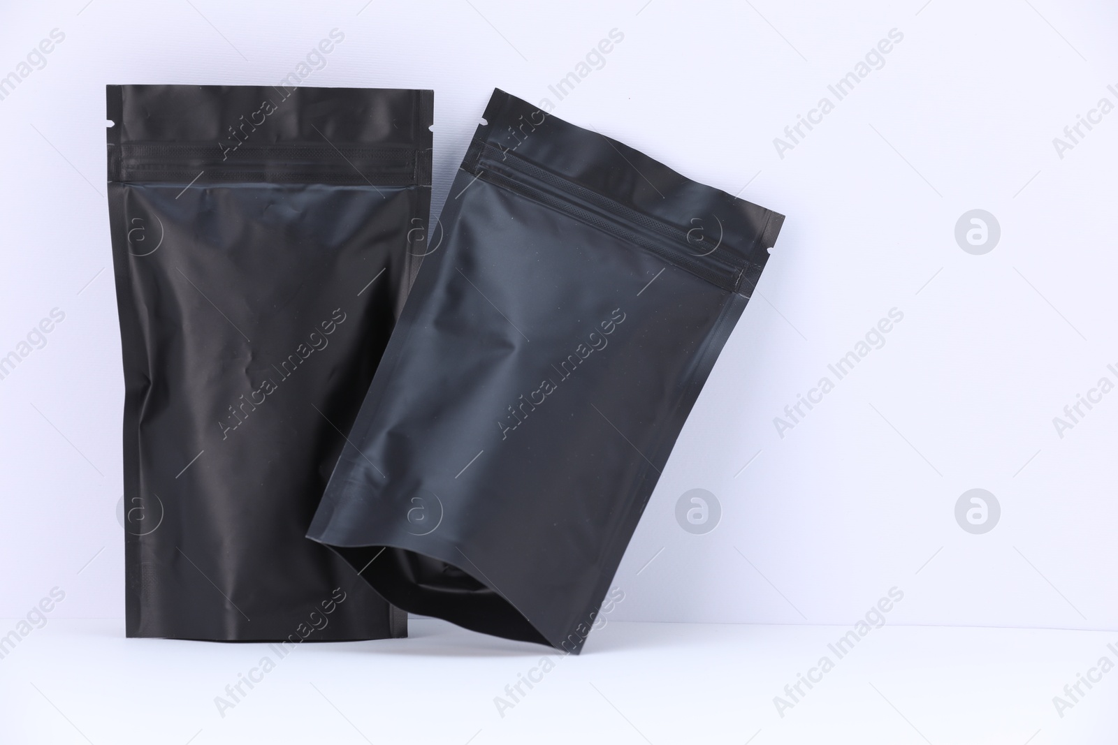 Zipper stand-up pouches on white background. Mockup for design Photo of Zipper stand-up pouches on white background. Mockup for design