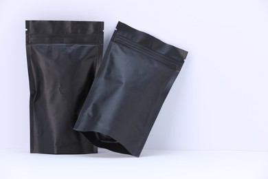 Photo of Zipper stand-up pouches on white background. Mockup for design