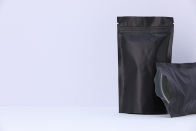 Photo of Zipper stand-up pouches on white background. Mockup for design