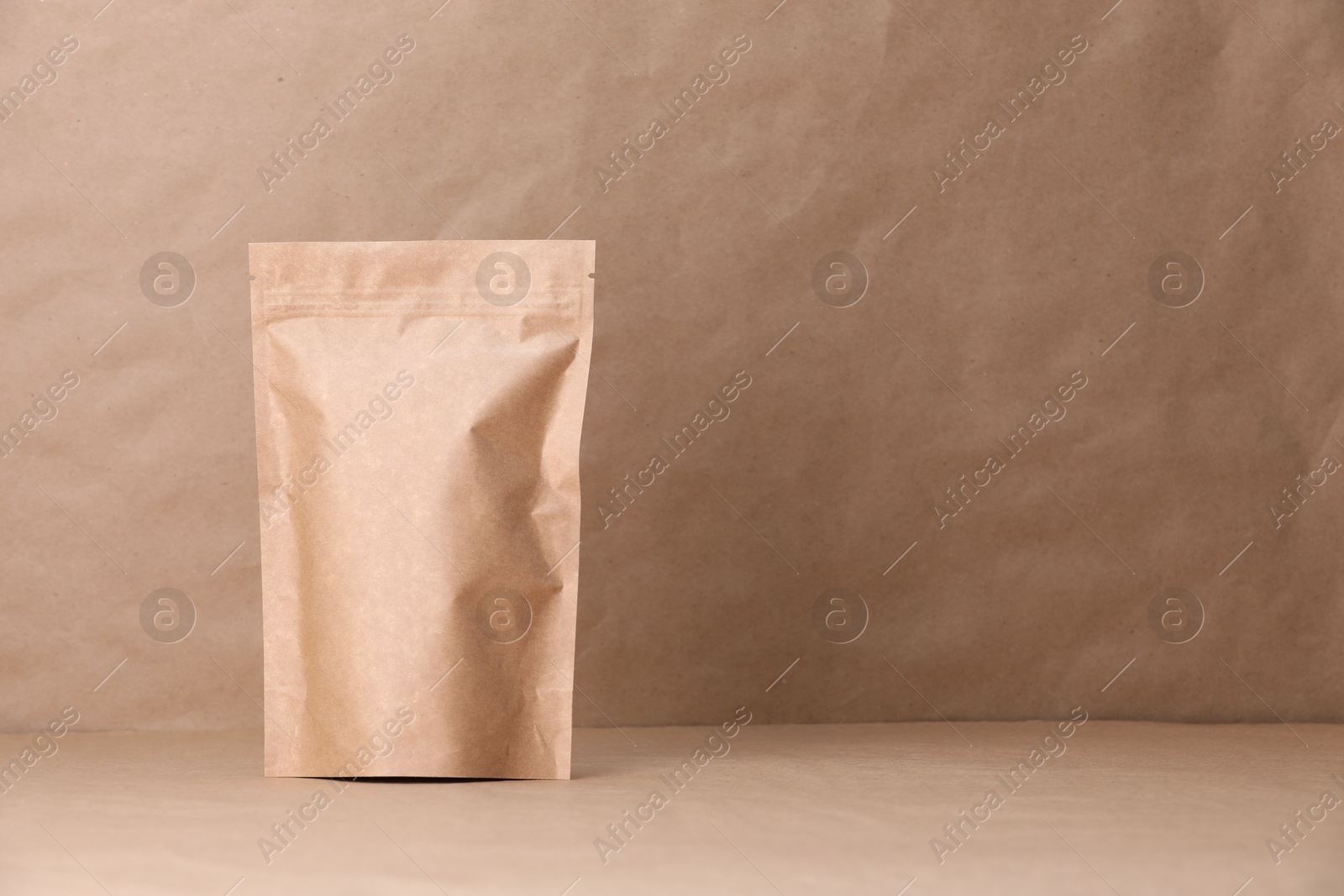 Zipper stand-up pouch on kraft paper background. Mockup for design Photo of Zipper stand-up pouch on kraft paper background. Mockup for design