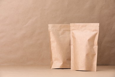 Photo of Zipper stand-up pouches on kraft paper background. Mockup for design