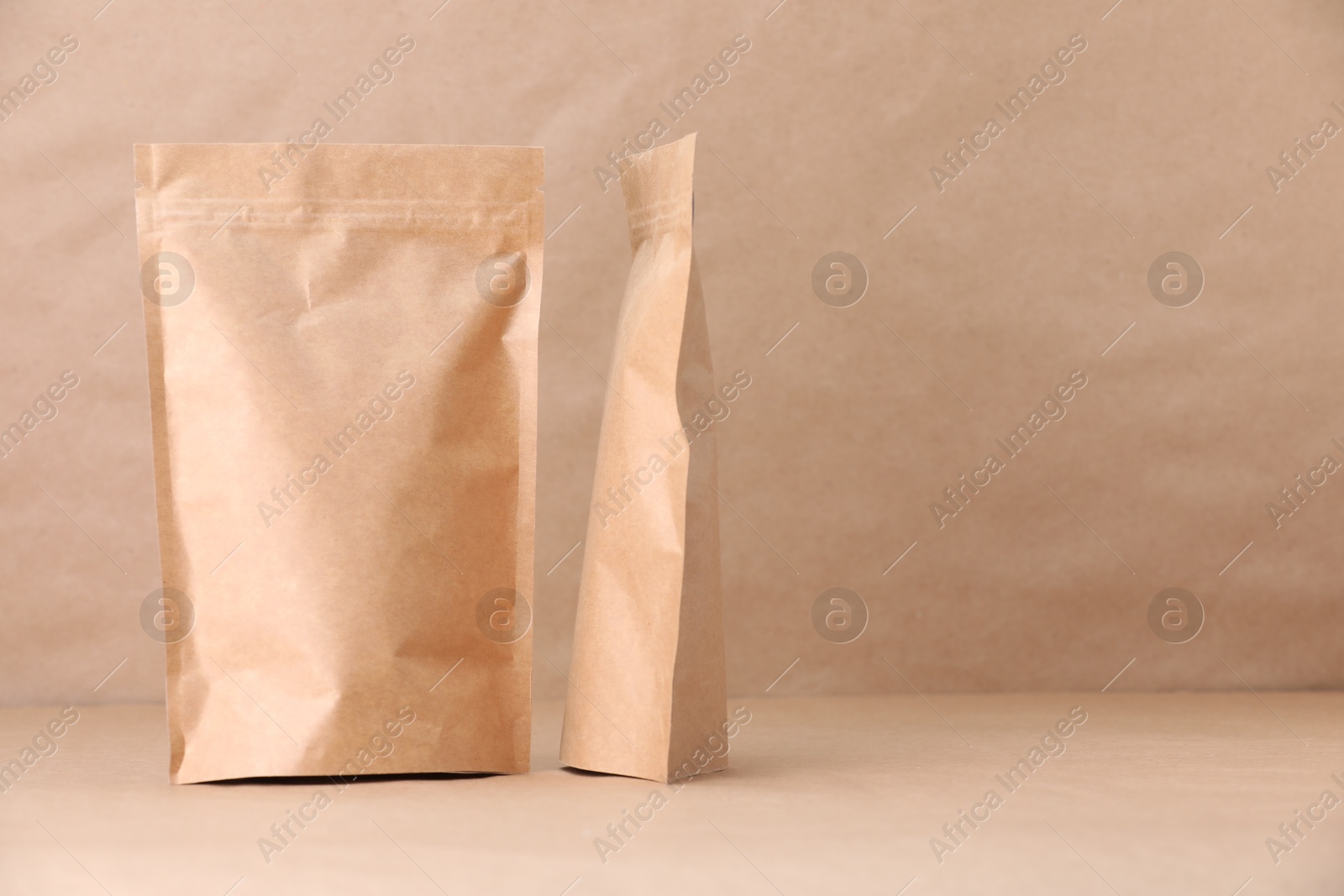 Zipper stand-up pouches on kraft paper background. Mockup for design Photo of Zipper stand-up pouches on kraft paper background. Mockup for design