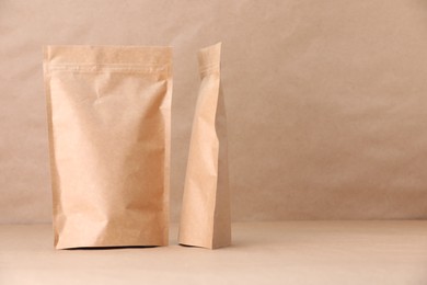 Photo of Zipper stand-up pouches on kraft paper background. Mockup for design