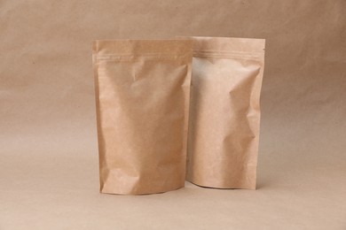 Photo of Zipper stand-up pouches on kraft paper background. Mockup for design