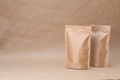 Photo of Zipper stand-up pouches on kraft paper background. Mockup for design