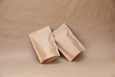 Photo of Zipper stand-up pouches on kraft paper background. Mockup for design