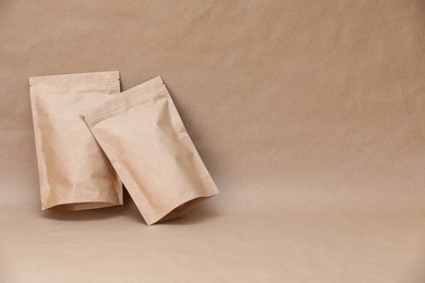 Photo of Zipper stand-up pouches on kraft paper background. Mockup for design
