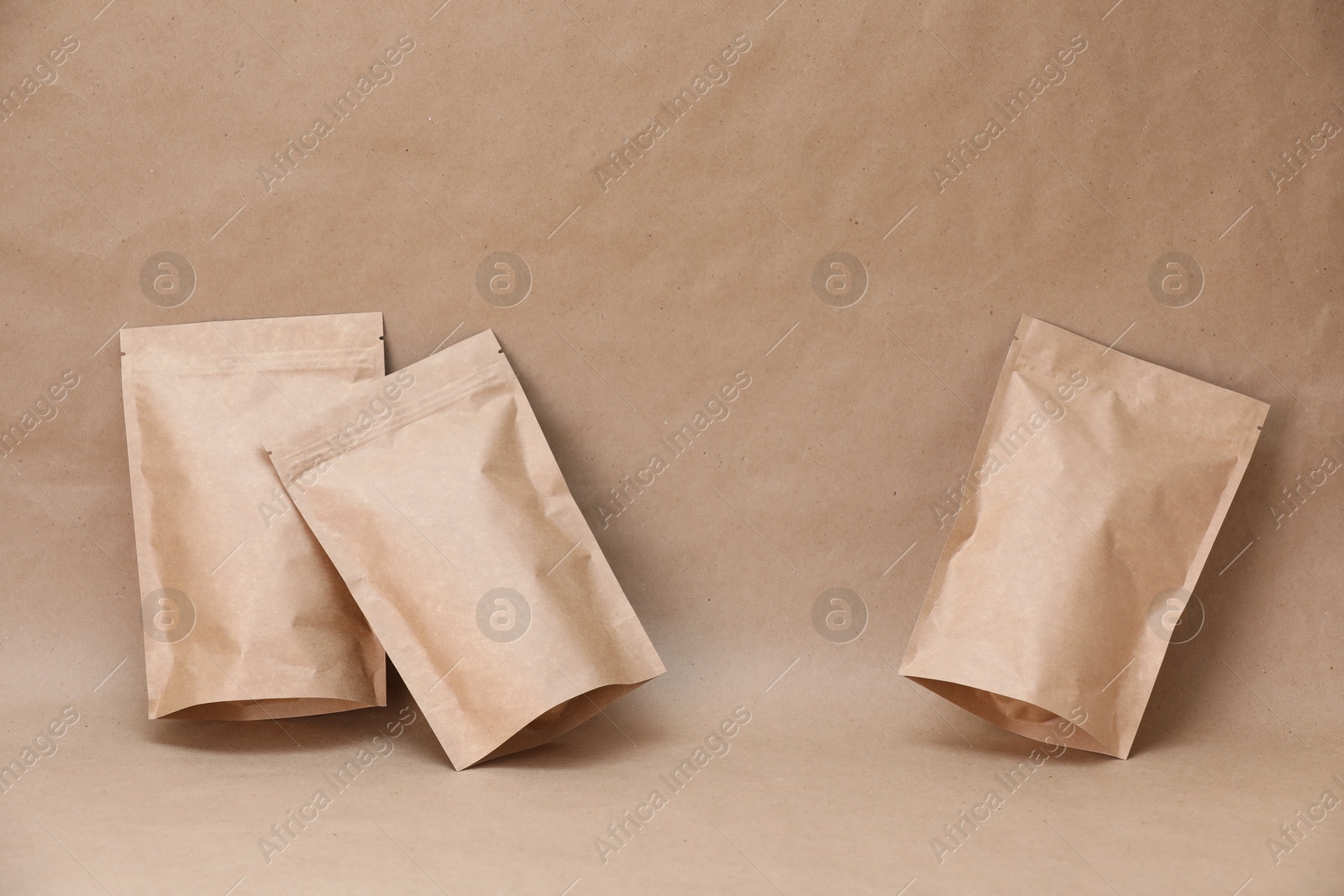 Zipper stand-up pouches on kraft paper background. Mockup for design Photo of Zipper stand-up pouches on kraft paper background. Mockup for design
