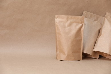 Photo of Zipper stand-up pouches on kraft paper background. Mockup for design
