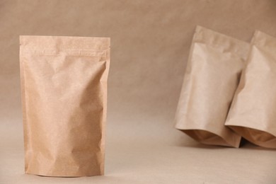 Photo of Zipper stand-up pouches on kraft paper background. Mockup for design