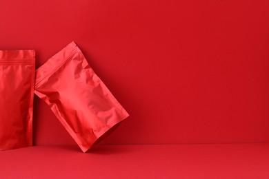 Photo of Zipper stand-up pouches on red background. Mockup for design