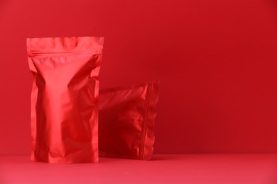 Photo of Zipper stand-up pouches on red background. Mockup for design