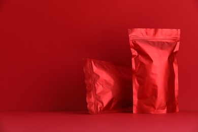 Photo of Zipper stand-up pouches on red background. Mockup for design