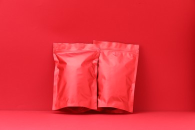 Photo of Zipper stand-up pouches on red background. Mockup for design