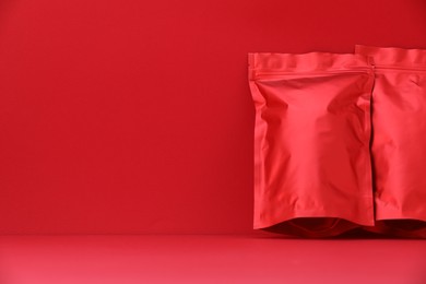 Photo of Zipper stand-up pouches on red background. Mockup for design