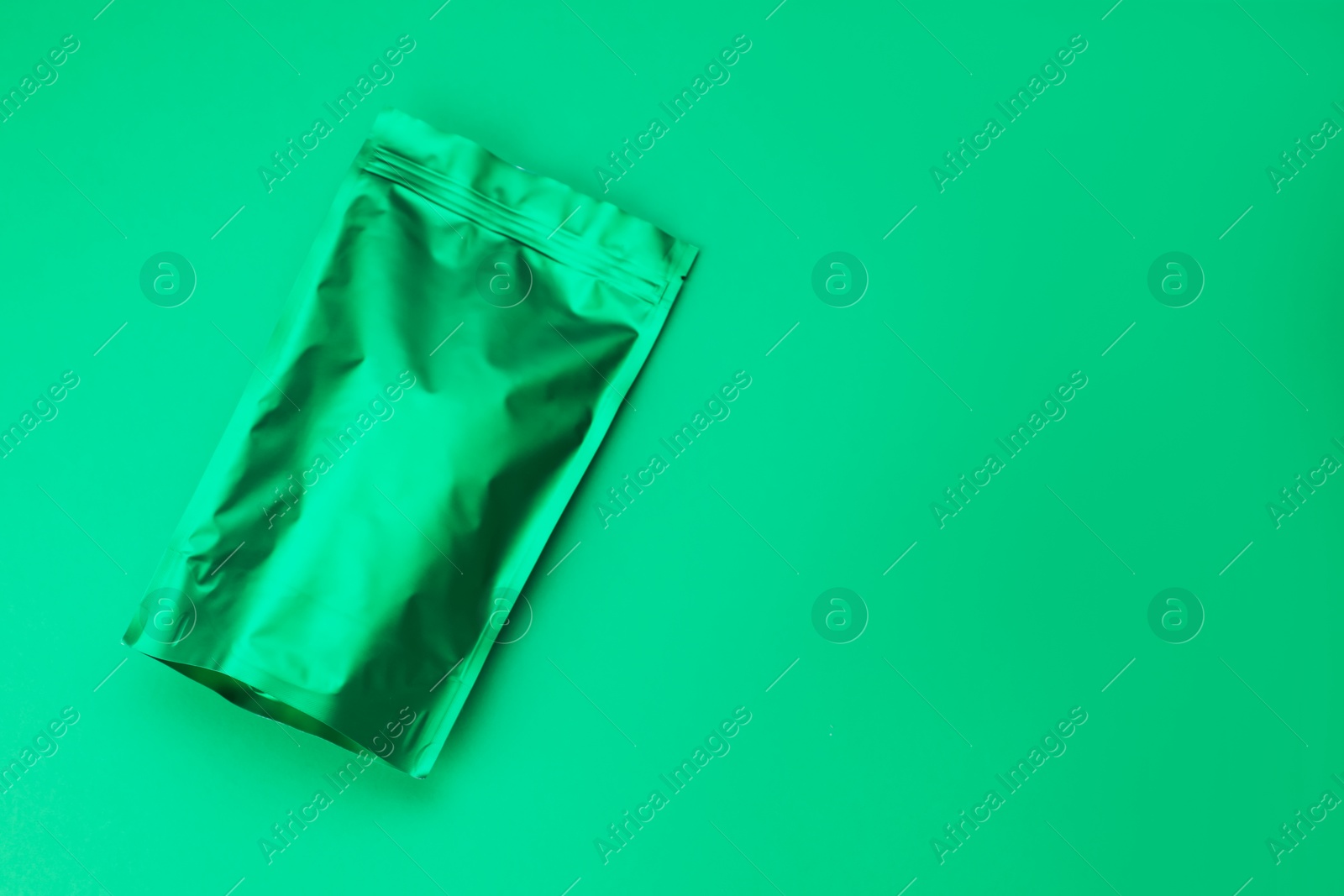 Photo of Zipper stand-up pouch on green background. Mockup for design