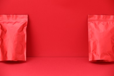 Photo of Zipper stand-up pouches on red background. Mockup for design