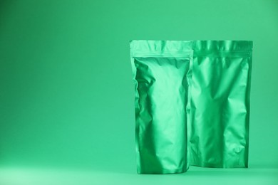 Photo of Zipper stand-up pouches on green background. Mockup for design