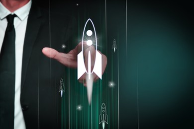 Image of Business, successful startup. Man launching rocket on virtual screen against dark green background, closeup