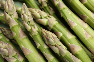 Photo of Many fresh raw asparagus spears as background, closeup