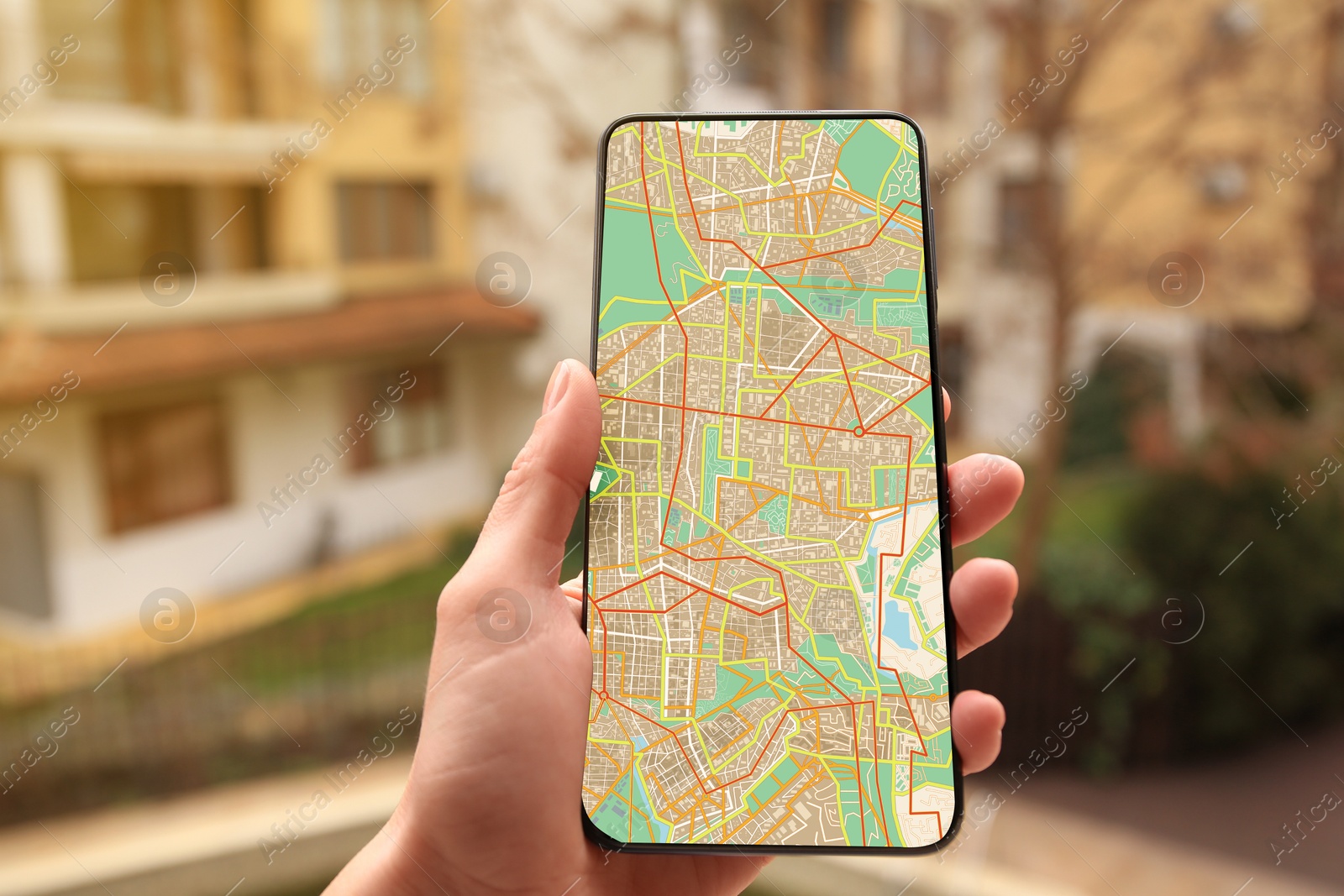 Woman looking at city map on her mobile phone outdoors, closeup Image of Woman looking at city map on her mobile phone outdoors, closeup