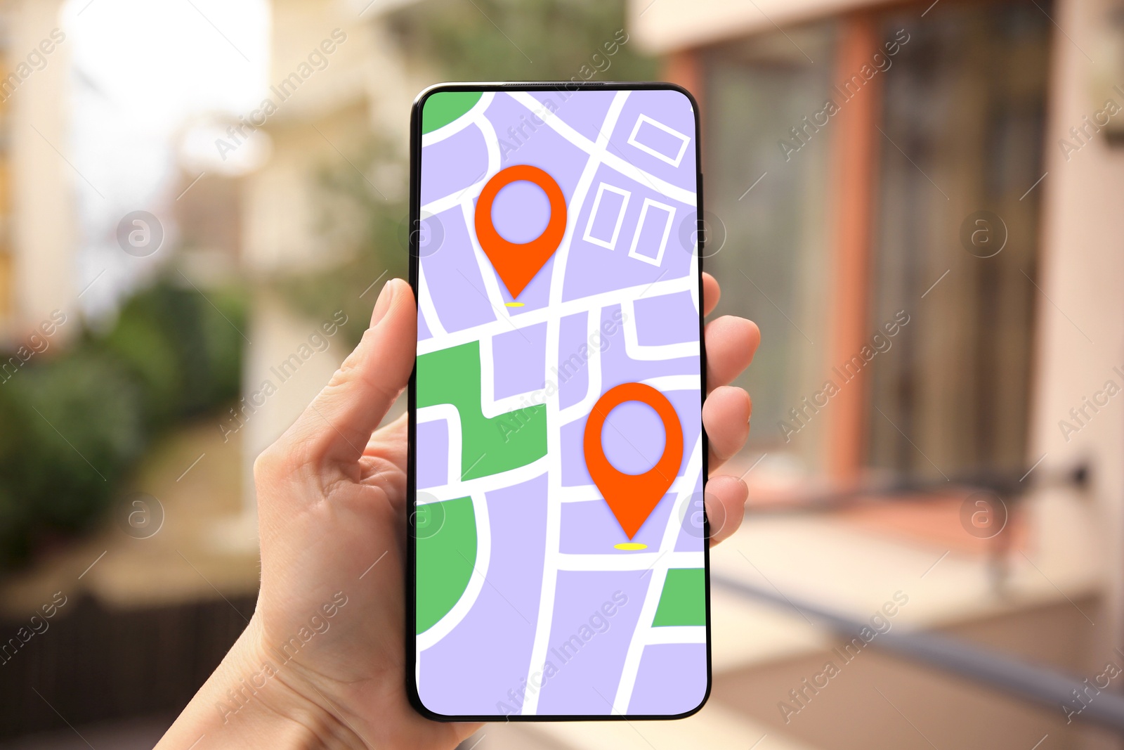 Woman looking at city map on her mobile phone outdoors, closeup Image of Woman looking at city map on her mobile phone outdoors, closeup