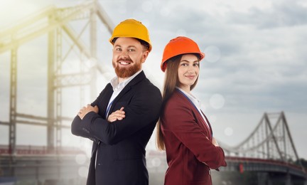Image of Construction engineers in hard hats against bridge outdoors