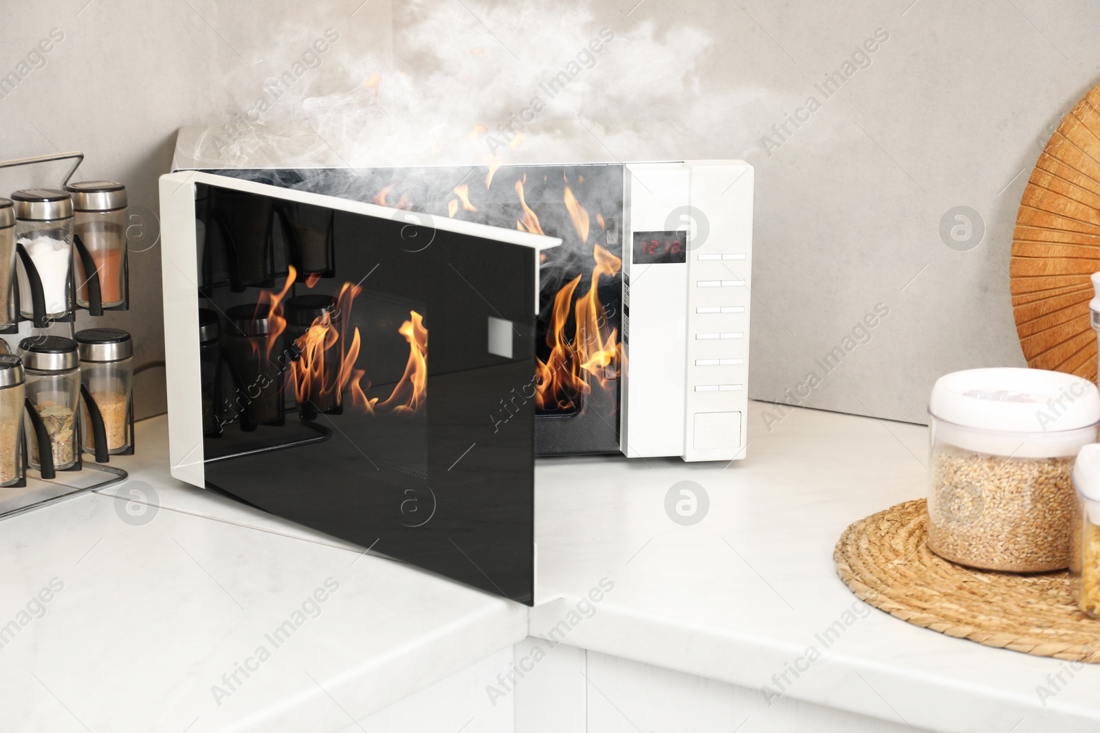 Microwave oven burning inside on countertop in kitchen Image of Microwave oven burning inside on countertop in kitchen