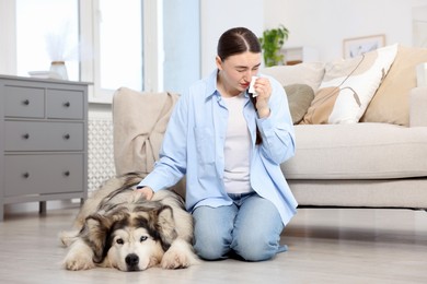 Photo of Woman suffering from allergy with her dog at home