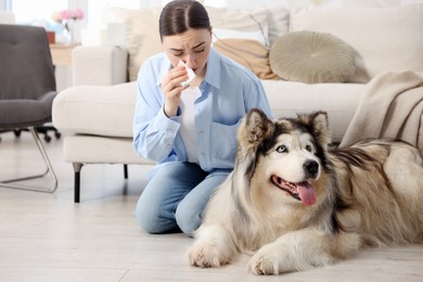 Photo of Woman suffering from allergy with her dog at home
